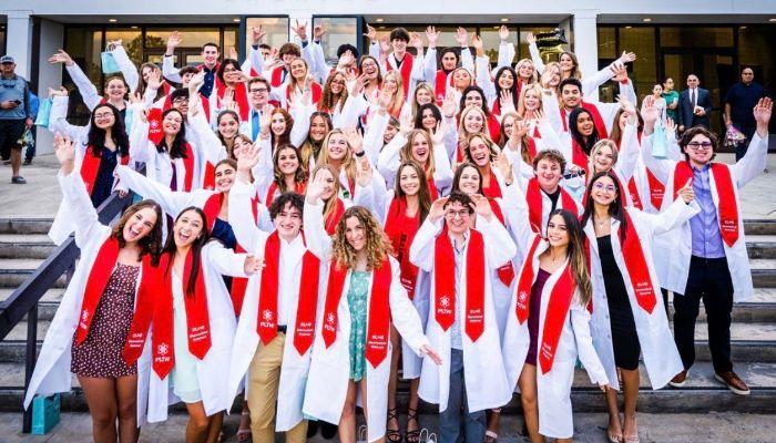 Students celebrating receiving their Biomedical Sciences Academy White coats