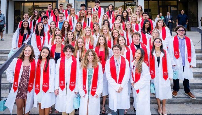 Students celebrating receiving their Biomedical Sciences Academy White coats