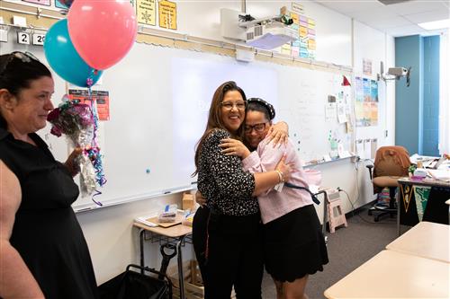 teacher hugging principal