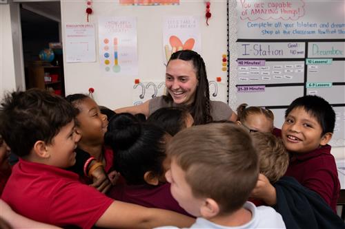 teacher hugging students