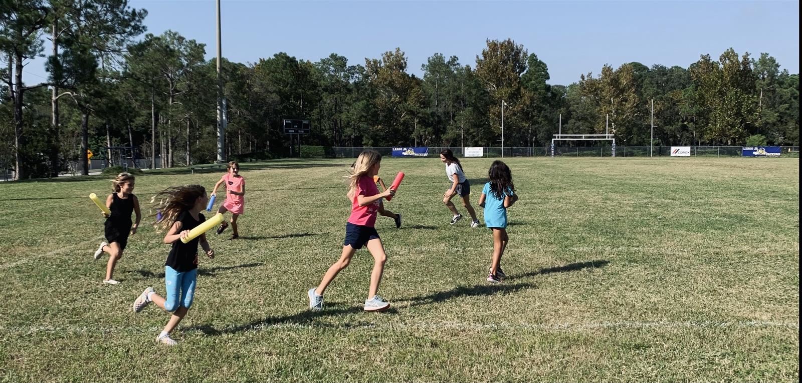 Girls on the Run participants playing socially distanced tag. Girls on the Run participants playing socially distanced tag.