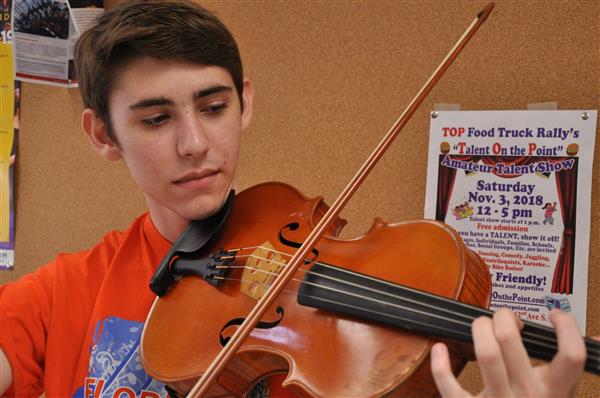 Senior Stefan Mason, above, plays viola in the band room on Nov. 30. Mason made it into the All State Orchestra 