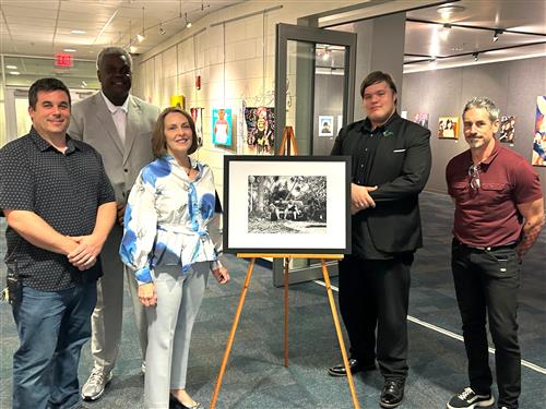  Student with teachers in front of artwork