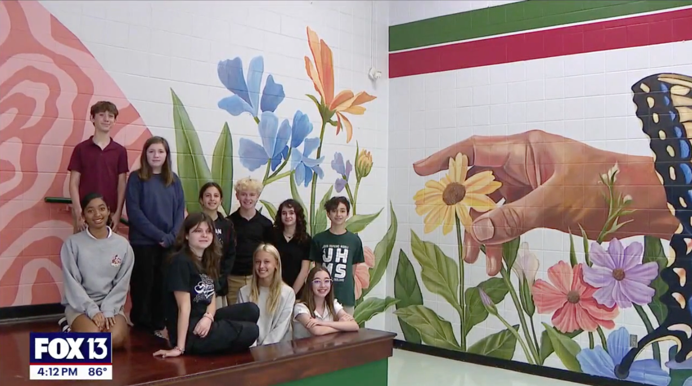  students in front of their mural