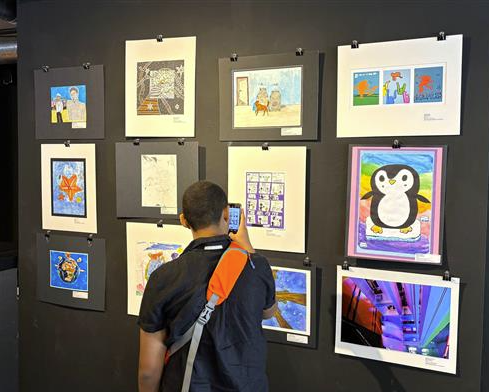  Parent photographing artwork