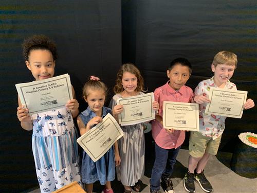 Students displaying their award certificates 