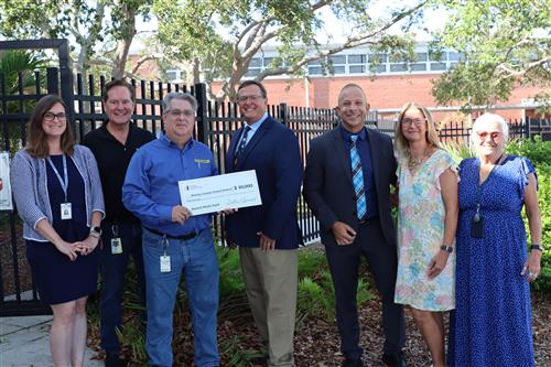 Dollar General Foundation presents check to Principals Bob Kalach and Chris Ateek