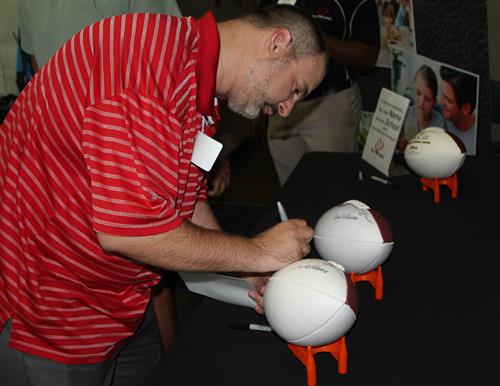 Team captain signing a football 