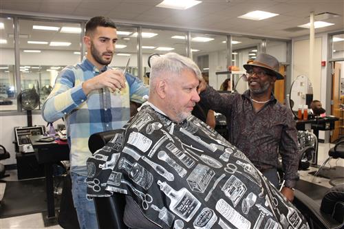 Instructor Charles Harris (far right) started cutting hair at the age of 14 and currently owns two barbershops.  