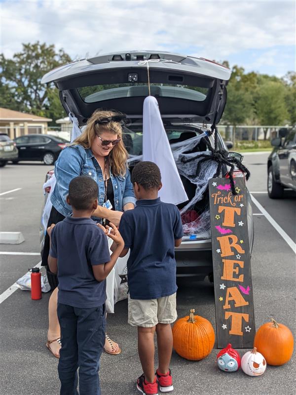 Teachers Showing Off Their Costumes at Trunk-or-Treat