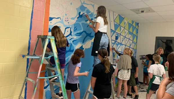 PCS Visual Arts Summer Mural Camp students paint a school mural at Safety Harbor Middle School.