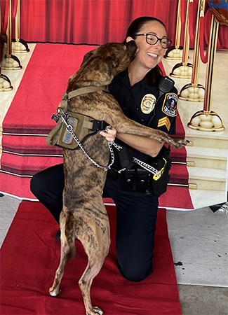 Police dog and officer are getting ready for the start of school.