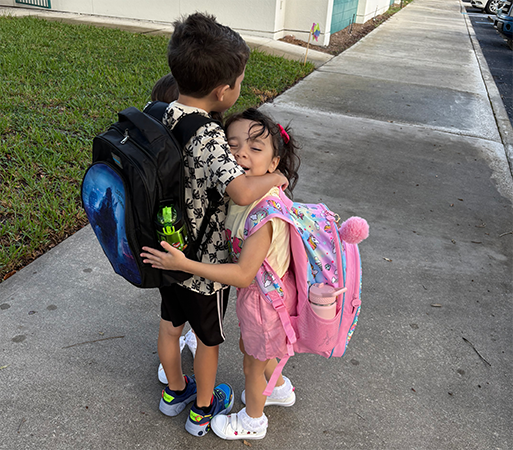 Students hug on the first day of school.